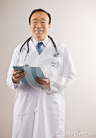 Doctor wearing lab coat and stethoscope Stock Photo