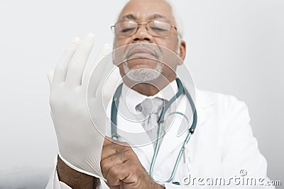 Doctor Wearing Protective Gloves At Clinic Stock Photo