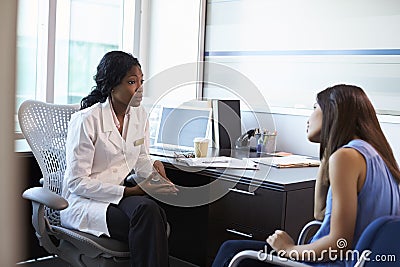 Doctor Wearing White Coat Meeting With Female Patient Stock Photo