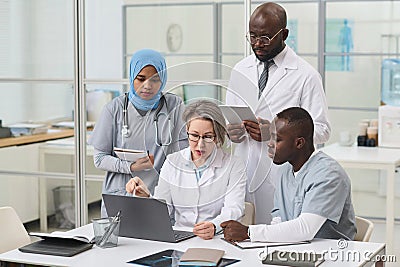 Doctor discussing difficult disease with her colleagues Stock Photo