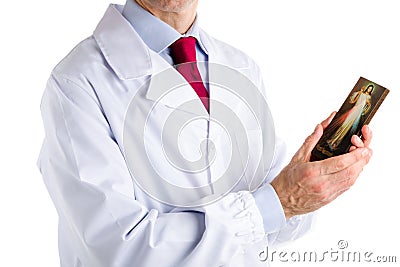 Doctor in white coat holding Merciful Jesus icon Stock Photo