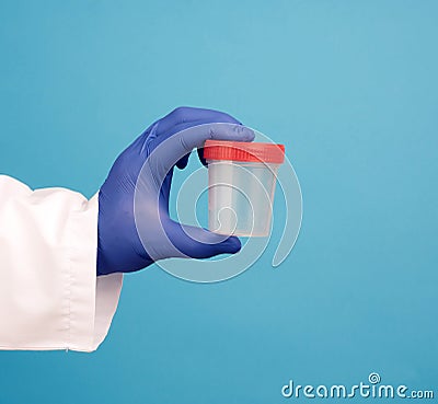 Doctor in a white coat holds a empty plastic container for urine specimen Stock Photo