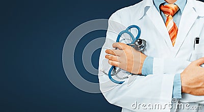 Doctor In White Coat With A Stethoscope Crosses His Arms Over His Chest Copy-space On Blue Background. Healthcare Medicine Concept Stock Photo