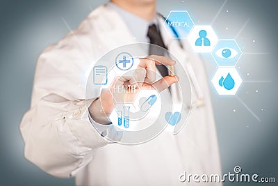 A doctor in white holding a pill Stock Photo