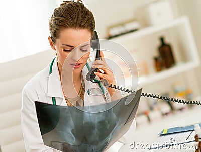 Doctor woman with fluorography talking phone Stock Photo