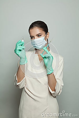 Doctor woman holding syringe and ampoule ready for injecting on white background. Medicine, cosmetology and vaccination concept Stock Photo