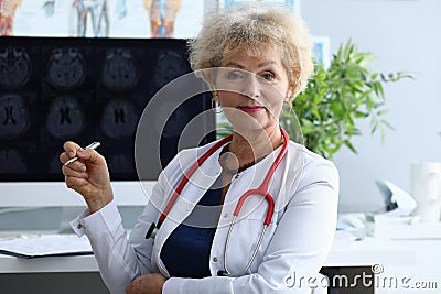 Doctor woman holds pen on background an x-ray Stock Photo