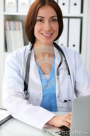 Doctor woman at work. Physician typing on laptop computer. Medicine, healthcare concept Stock Photo