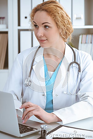 Doctor woman at work. Physician typing on laptop computer. Medicine, healthcare concept Stock Photo