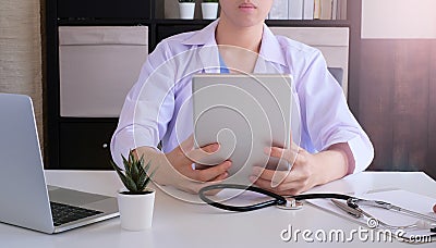 Doctor work for online medical service. using tablet to consult with patient Stock Photo