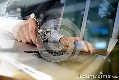 Doctor working with laptop computer in medical workspace office Stock Photo