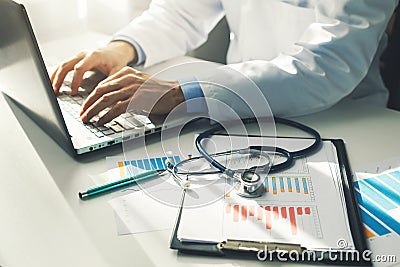 doctor working with medical statistics and financial reports Stock Photo