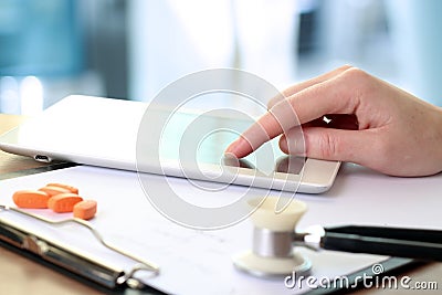 Doctor working with tablet computer. orange pills, prescriptio Stock Photo