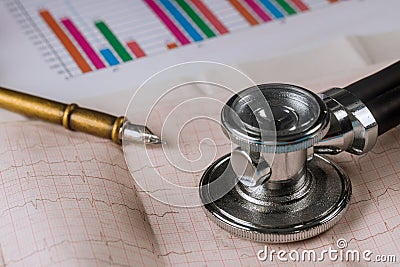Doctor workplace stethoscope on cardiogram sheet closeup Stock Photo