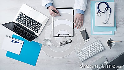 Doctor writing medical records Stock Photo