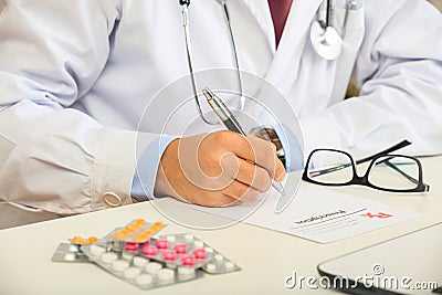 Doctor writing a perscription Stock Photo