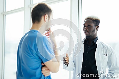 Doctoral meeting. Two mixed race Confident doctor standing in hospital Stock Photo