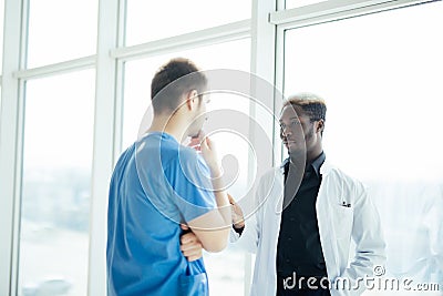 Doctoral meeting. Two mixed race Confident doctor standing in hospital Stock Photo