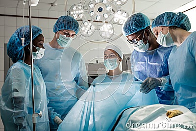 Doctors and assistants rejoicing at good resultss after difficult operation Stock Photo