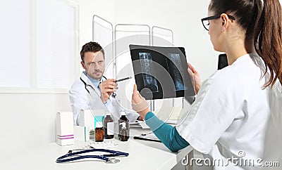 Doctors examining x-ray at office Stock Photo
