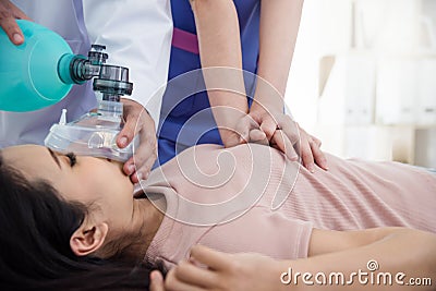 Doctors giving cardiac massage to a patient Stock Photo