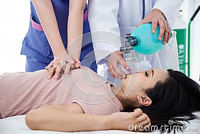 Doctors giving cardiac massage to a patient Stock Photo