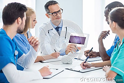 team of doctors having conversation and looking Editorial Stock Photo