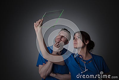 Doctors holding futuristic transparent tablet pc Stock Photo