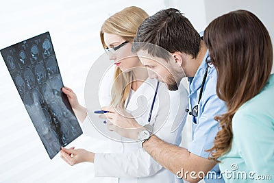 Doctors looking at brain MRI Stock Photo