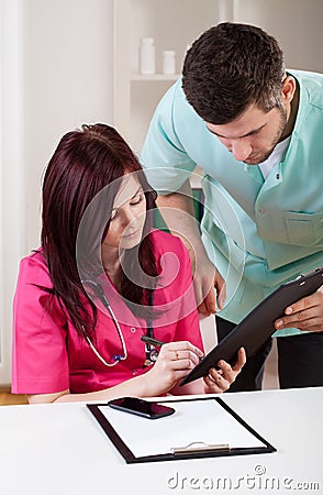 Doctors making medical notes Stock Photo