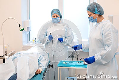 Doctors during a mole removal surgery Stock Photo