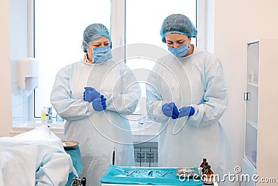 Doctors during a mole removal surgery in clinic Stock Photo