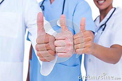 Doctors and nurse gesturing thumbs up Stock Photo