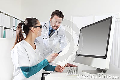Doctors with nurse looking medical records, concept of consult Stock Photo