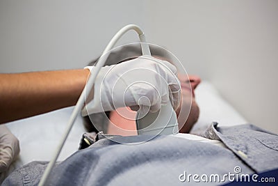 Doctors performing a doppler sonography on patient Stock Photo