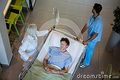 Doctors pushing emergency stretcher bed in corridor Stock Photo