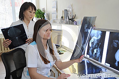 Doctors radiologists work in the laboratory with X-ray photographs. Stock Photo