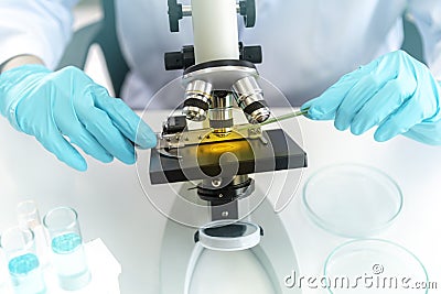 Doctors researched microscope slides under the monocular microscope. Close Up of the test sample under the monocular microscope in Stock Photo