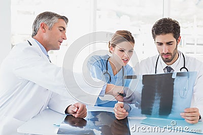 Doctors sitting together with x-rays Stock Photo