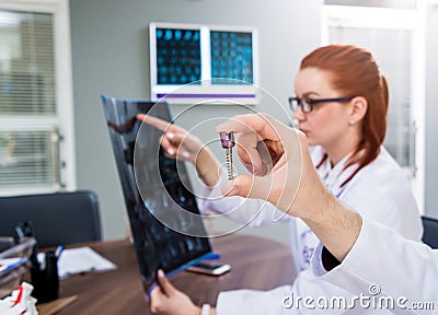 Doctors team having medical council in hospital. Spine fixation systems Stock Photo