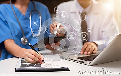 Doctors working together with mobile phone and stethoscope and digital tablet laptop. Stock Photo