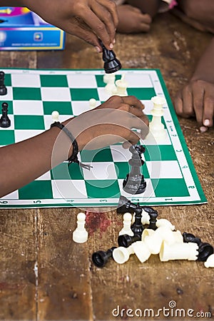 Documentary editorial image. Children playing chess at the table. the concept of childhood and board games, brain development and Editorial Stock Photo