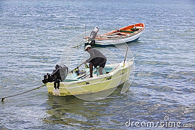 Documentary editorial image. Fisherman on small wood boat Editorial Stock Photo