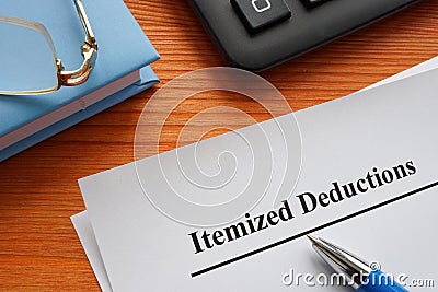 Documents about Itemized deductions on the wooden surface. Stock Photo
