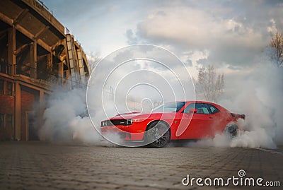 Dodge Challenger SRT Hellcat shrouded in smoke from its burning tires. Editorial Stock Photo