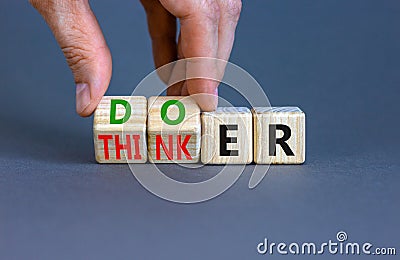 Doer or thinker symbol. Concept words Doer or thinker on wooden cubes. Businessman hand. Beautiful grey table grey background. Stock Photo