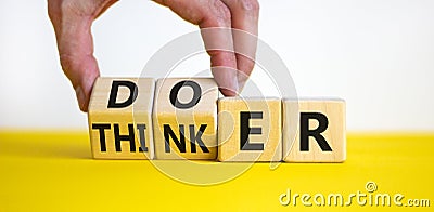 Doer or thinker symbol. Concept words Doer or thinker on wooden cubes. Businessman hand. Beautiful yellow table white background. Stock Photo