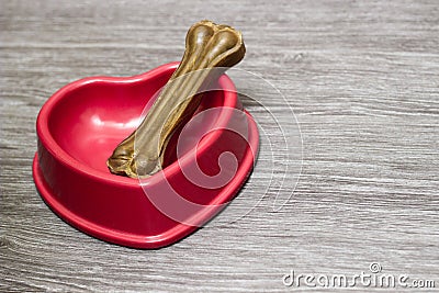 Dog bone in the red bowl Stock Photo