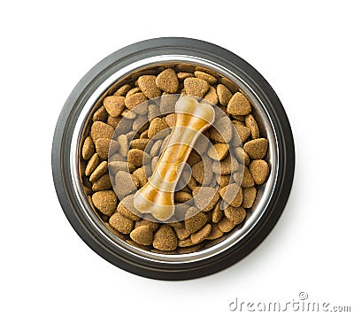 Dog chew bone and dry kibble dog food. Stock Photo