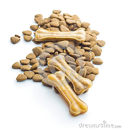 Dog chew bone and dry kibble dog food. Stock Photo